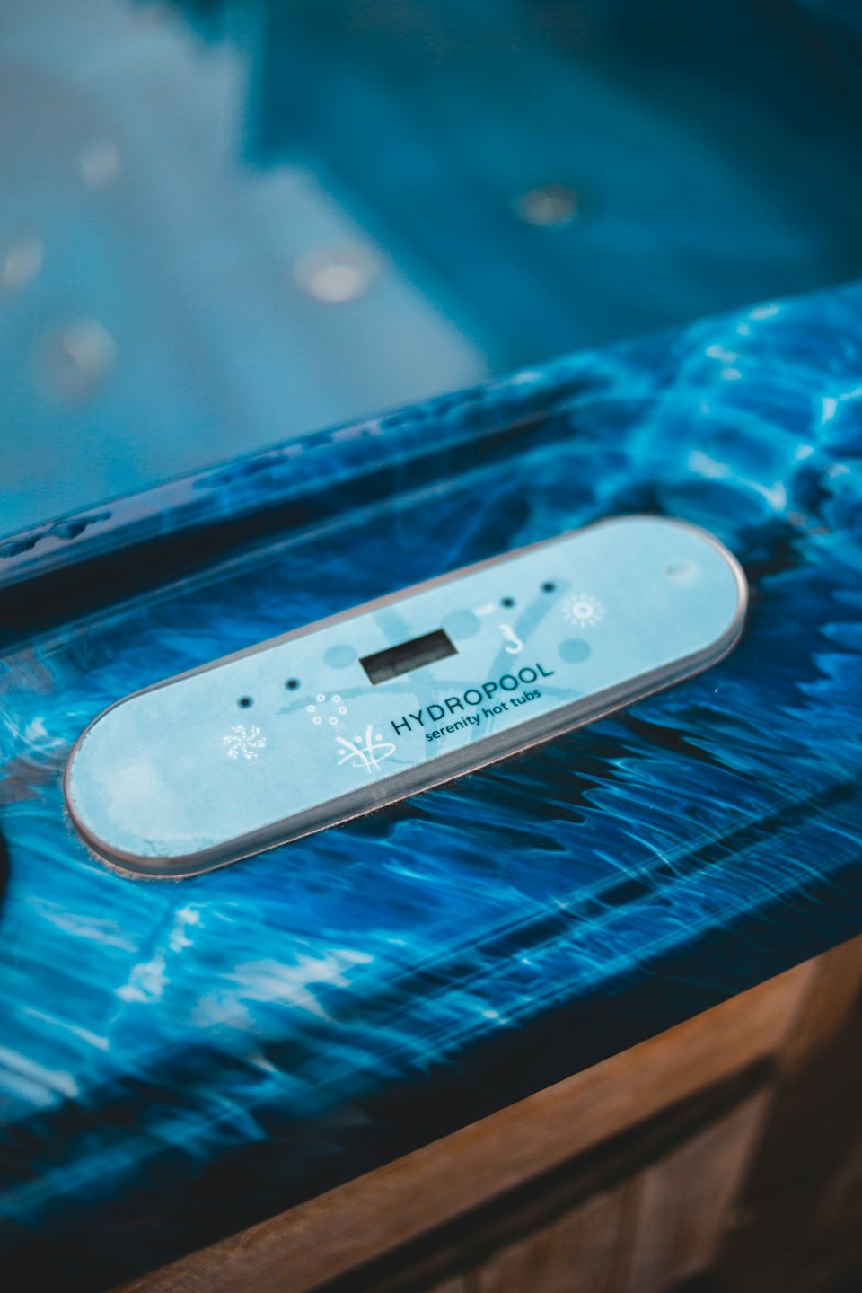 Digital control panel embedded in a textured blue hot tub surface.